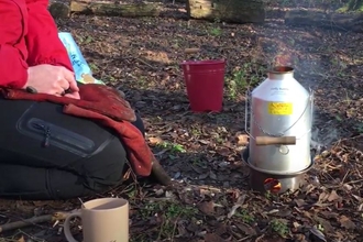 Kelly kettle being used in woodland
