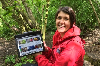 Education manager Vicky Dunne with online Wild About Learning hub on tablet