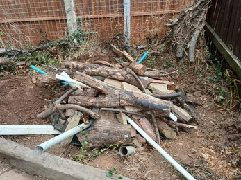 A pile of logs piled together with pipes for air which insects can enter