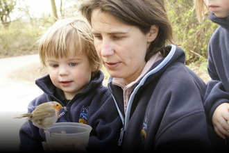 Nicholas Watts' daughter and grandson Vine House Farm feeding robin