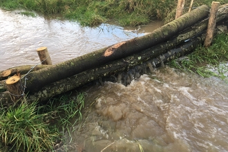 Leaky barrier at Slashpitts Farm during rainfall