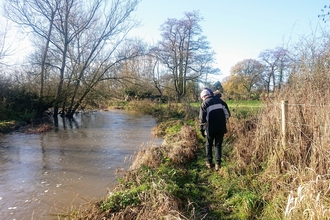 Walking along a river in winter