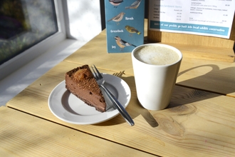 An image of a chocolate tart and a coffee at Brandon Marsh Cafe near Coventry