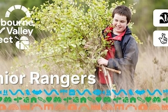 Sherbourne Valley Junior Rangers. Smiling teenager carrying branches in field