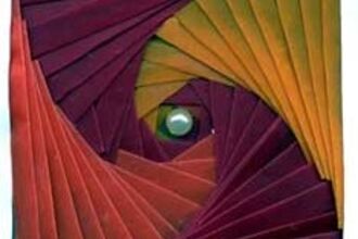 Folded iris paper craft made from pink, purple and yellow paper 