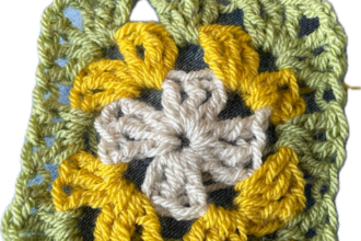 Crochet granny square in green yellow and cream yarn