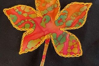 Applique orange leaf on a black fabric 