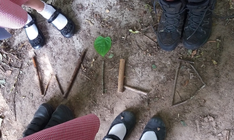 Children stick writing the word WILD