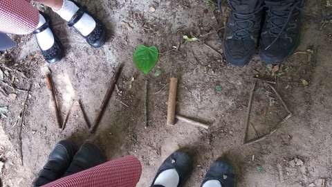 Children stick writing the word WILD