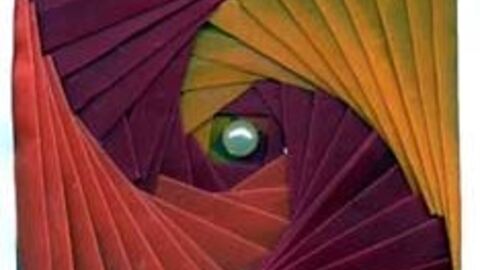 Folded iris paper craft made from pink, purple and yellow paper 