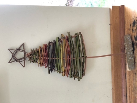 A rainbow Christmas tree formed out of willow branches