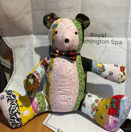 Photo of Lemmy the patchwork bear - a teddy made up of lots of different pieces of fabric