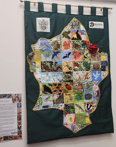 Photo of the patchwork map artwork with different shapes of fabric to make up the shape of leamington