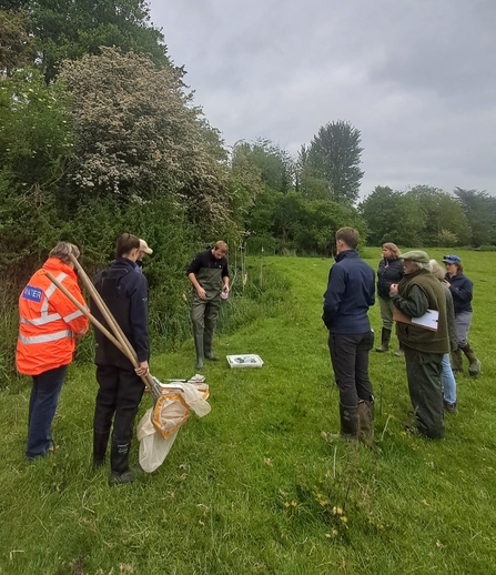 Group of people stood in a field, holding kick sampling equipment