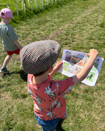 two boys walking with spotter sheet
