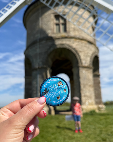 Hedgehog walk 2026 badge in front of a windmill