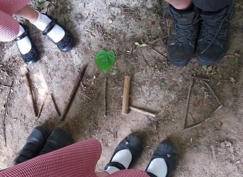 Children stick writing the word WILD