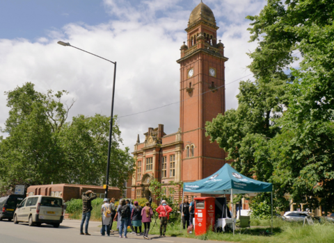 Photo of Leamington town hall with the peregrine watch stall and a queue of people in front