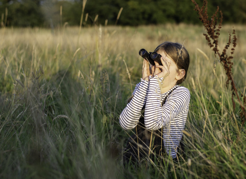 Girl using binoculars